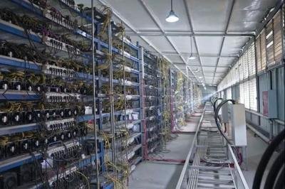 A large mining farm showcasing rows of mining machines in operation